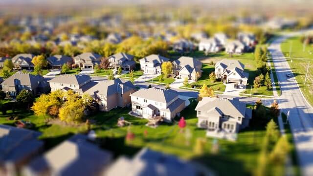 Birds-eye view of a neighborhood with large homes and green lawns