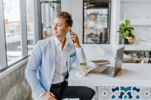 Person in a blue blazer talking on the phone