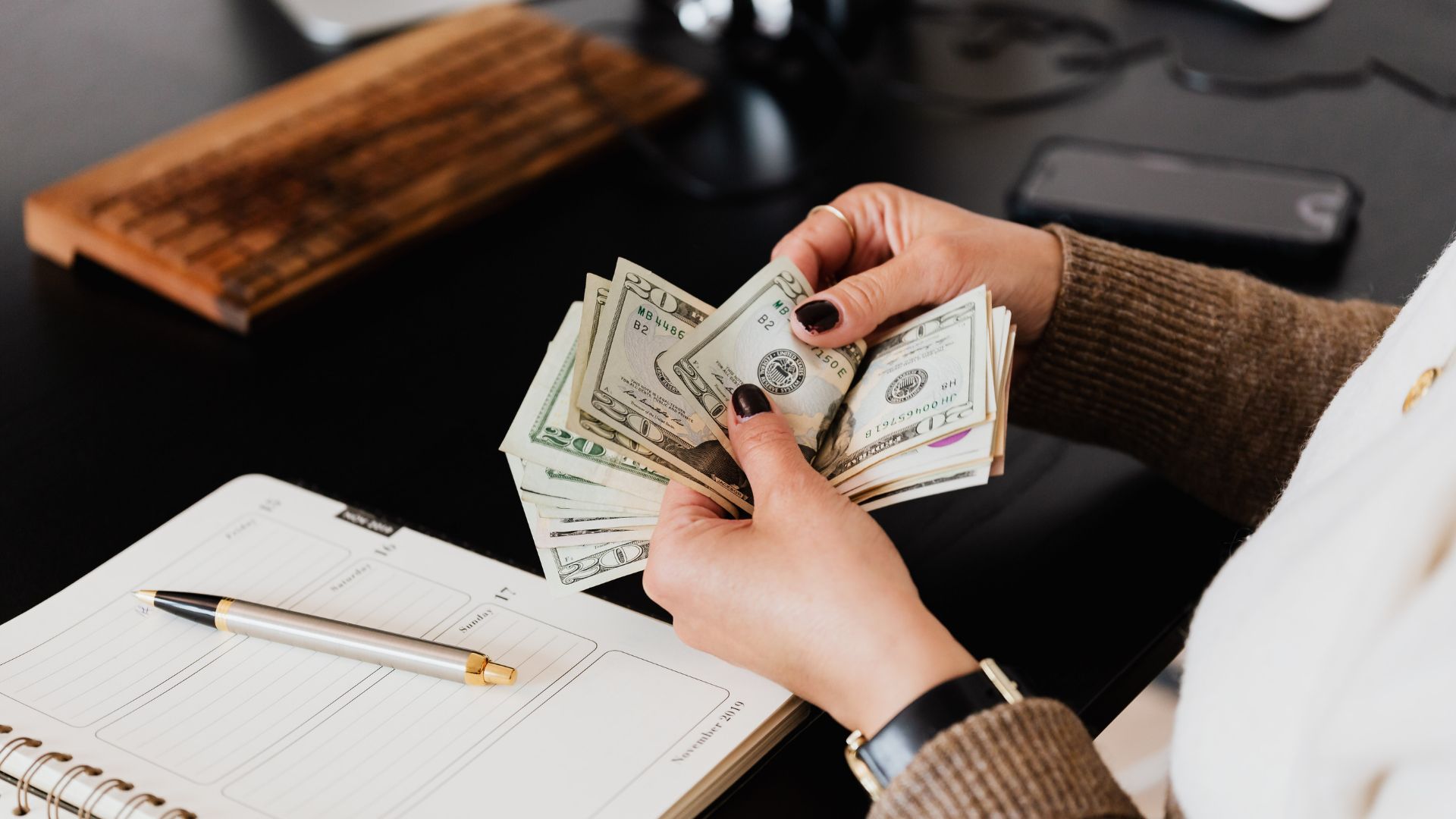 person counting money bills