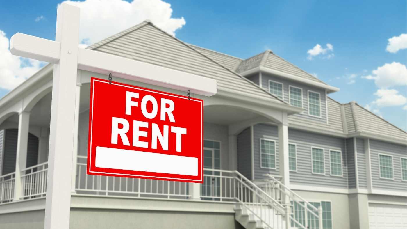 Single-family home with a red For Rent sign in front of it