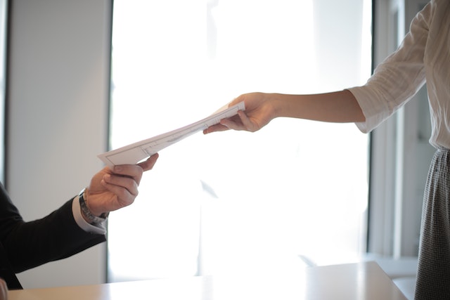 hands exchanging rental agreement